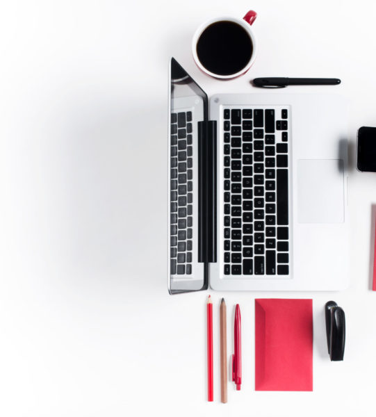 Concept of comfortable workplaces. Hands and gadgets on the white desk