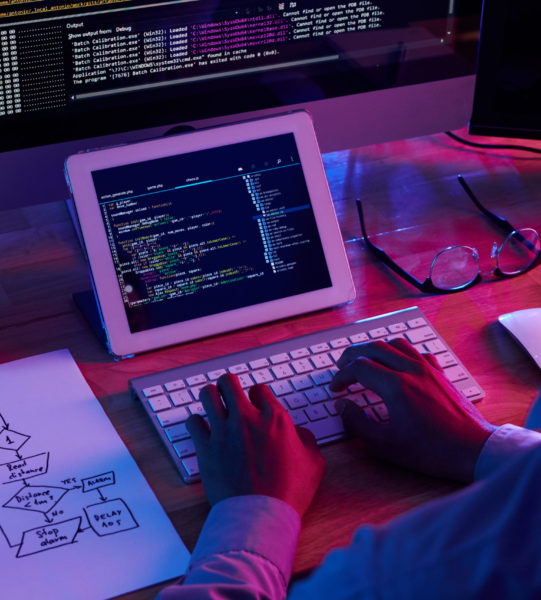 Programmer working at IT company office late at night
